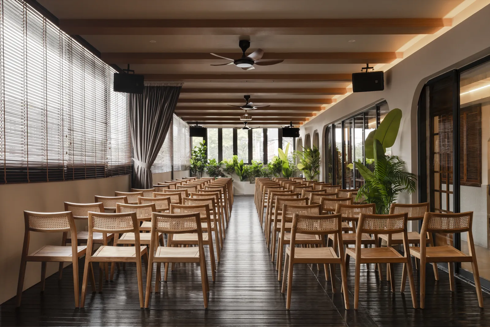 Premium Balinese-inspired event space with natural wood textures and ambient lighting